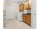 Functional laundry room featuring tile flooring, a washer and dryer, and built-in cabinets for extra storage at 1242 E Bartlett Way, Chandler, AZ 85249