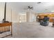 Bright and airy living area featuring carpet floors, fan, and easy access to the kitchen at 1242 E Bartlett Way, Chandler, AZ 85249