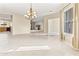 Spacious living room with tile floors, large windows, and elegant chandelier that create a bright and inviting atmosphere at 1242 E Bartlett Way, Chandler, AZ 85249