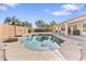 Sparkling pool with a tanning ledge surrounded by desert landscaping and block wall for privacy at 1242 E Bartlett Way, Chandler, AZ 85249