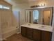 Bathroom featuring double sinks, a bathtub and a large mirror at 1244 S Portland Ave, Gilbert, AZ 85296