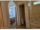 Bathroom with a bathtub, a small closet, and access to bedroom at 1244 S Portland Ave, Gilbert, AZ 85296