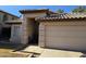 Tan house with tile roof, two-car garage, and walkway at 1244 S Portland Ave, Gilbert, AZ 85296