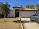 Tan house with tile roof, two-car garage, and landscaping at 1244 S Portland Ave, Gilbert, AZ 85296