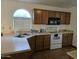 Galley kitchen with wood cabinets and a double sink at 1244 S Portland Ave, Gilbert, AZ 85296