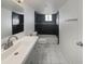 Updated bathroom with dark tile, a soaking tub, and gray vanity at 130 N 95Th Pl, Mesa, AZ 85207