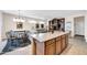 Kitchen with island, dining area with glass table at 15506 W Skyview Way, Surprise, AZ 85374