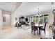 Bright living and dining room with tile floors and large windows at 15506 W Skyview Way, Surprise, AZ 85374