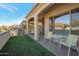 Covered patio with artificial turf and seating area, offering a private outdoor space at 16914 W Merrell St, Goodyear, AZ 85395