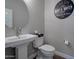 Small bathroom with pedestal sink and decorative mirror at 16914 W Merrell St, Goodyear, AZ 85395