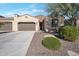 Single-story home with two-car garage, landscaped yard, and desert landscaping at 16914 W Merrell St, Goodyear, AZ 85395