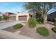 Single-story home with a two-car garage and well-maintained landscaping at 16914 W Merrell St, Goodyear, AZ 85395