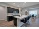 Modern kitchen with an island, dark cabinetry and stainless steel appliances at 16914 W Merrell St, Goodyear, AZ 85395