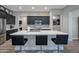 Modern kitchen with dark cabinetry, quartz countertops, and stainless steel appliances at 16914 W Merrell St, Goodyear, AZ 85395