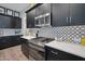 Stylish kitchen with dark cabinets, contemporary backsplash and stainless steel appliances at 16914 W Merrell St, Goodyear, AZ 85395