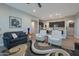 Open-concept living room with a view of the kitchen and modern decor at 16914 W Merrell St, Goodyear, AZ 85395