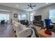 Bright living room with hardwood floors, fireplace, and comfortable seating at 16914 W Merrell St, Goodyear, AZ 85395