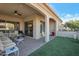 Relaxing covered patio with artificial turf and comfortable seating area at 16914 W Merrell St, Goodyear, AZ 85395