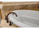 Close up of oval soaking tub with bronze faucet at 17730 W Redwood Ln, Goodyear, AZ 85338