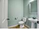 Small bathroom with pedestal sink and light green walls at 17730 W Redwood Ln, Goodyear, AZ 85338