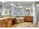 Primary bathroom with soaking tub and double vanity at 17730 W Redwood Ln, Goodyear, AZ 85338