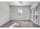 Bright bedroom with carpet and plantation shutters at 17730 W Redwood Ln, Goodyear, AZ 85338