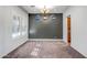 Formal dining room with dark-gray accent wall and carpeting at 17730 W Redwood Ln, Goodyear, AZ 85338