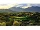 Scenic view of a golf course with mountain backdrop at 17730 W Redwood Ln, Goodyear, AZ 85338