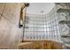 Bathroom shower with glass block feature wall and tiled surround at 17730 W Redwood Ln, Goodyear, AZ 85338