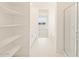 Bathroom featuring a glass shower and shelves at 17803 W Elm St, Goodyear, AZ 85395