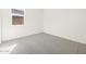 Neutral bedroom with plush carpet, window, and ample natural light at 17803 W Elm St, Goodyear, AZ 85395