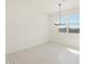 Light-filled dining room with stylish chandelier and a large window for enjoying views at 17803 W Elm St, Goodyear, AZ 85395