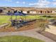 Attractive neighborhood playground with a modern shade structure adjacent to sidewalks and lawn at 17803 W Elm St, Goodyear, AZ 85395