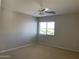 Bright bedroom featuring a window with blinds and neutral decor at 18546 E Oak Hill Ln, Queen Creek, AZ 85142