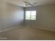 Bright bedroom featuring a window with blinds and neutral decor at 18546 E Oak Hill Ln, Queen Creek, AZ 85142