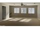 Bright bonus room with neutral walls, carpet, and three windows at 18546 E Oak Hill Ln, Queen Creek, AZ 85142