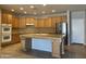 Kitchen with island, double oven, and wood cabinets at 18546 E Oak Hill Ln, Queen Creek, AZ 85142