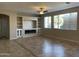 Living room with built-in shelving, fireplace, and tile floors at 18546 E Oak Hill Ln, Queen Creek, AZ 85142