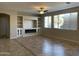 Living room with built-in shelving, fireplace, and tile floors at 18546 E Oak Hill Ln, Queen Creek, AZ 85142