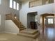 Elegant staircase with wood railings and high ceilings at 18546 E Oak Hill Ln, Queen Creek, AZ 85142