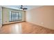 Well lit bedroom with wood floors and a large window at 18852 N Aztec Dr, Sun City, AZ 85373