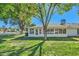 Home with large sunroom surrounded by lush landscaping at 18852 N Aztec Dr, Sun City, AZ 85373