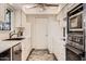 Efficient kitchen featuring ample white cabinetry, modern appliances, and stone-look flooring at 18852 N Aztec Dr, Sun City, AZ 85373