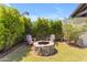 Relaxing backyard firepit area with stone firepit and comfortable seating at 21961 E Via De Arboles St, Queen Creek, AZ 85142