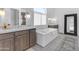 Elegant bathroom with soaking tub and double vanity at 21961 E Via De Arboles St, Queen Creek, AZ 85142