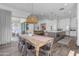 Farmhouse dining table with seating for six in kitchen area at 21961 E Via De Arboles St, Queen Creek, AZ 85142