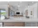 Kitchen island with sink, white quartz countertop, and gold fixtures at 21961 E Via De Arboles St, Queen Creek, AZ 85142