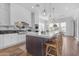 Modern kitchen with island, stainless steel appliances, and white cabinetry at 21961 E Via De Arboles St, Queen Creek, AZ 85142