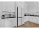 White kitchen with stainless steel appliances and ample cabinet storage at 21961 E Via De Arboles St, Queen Creek, AZ 85142