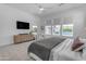 Main bedroom with large windows, TV, and pool view at 21961 E Via De Arboles St, Queen Creek, AZ 85142